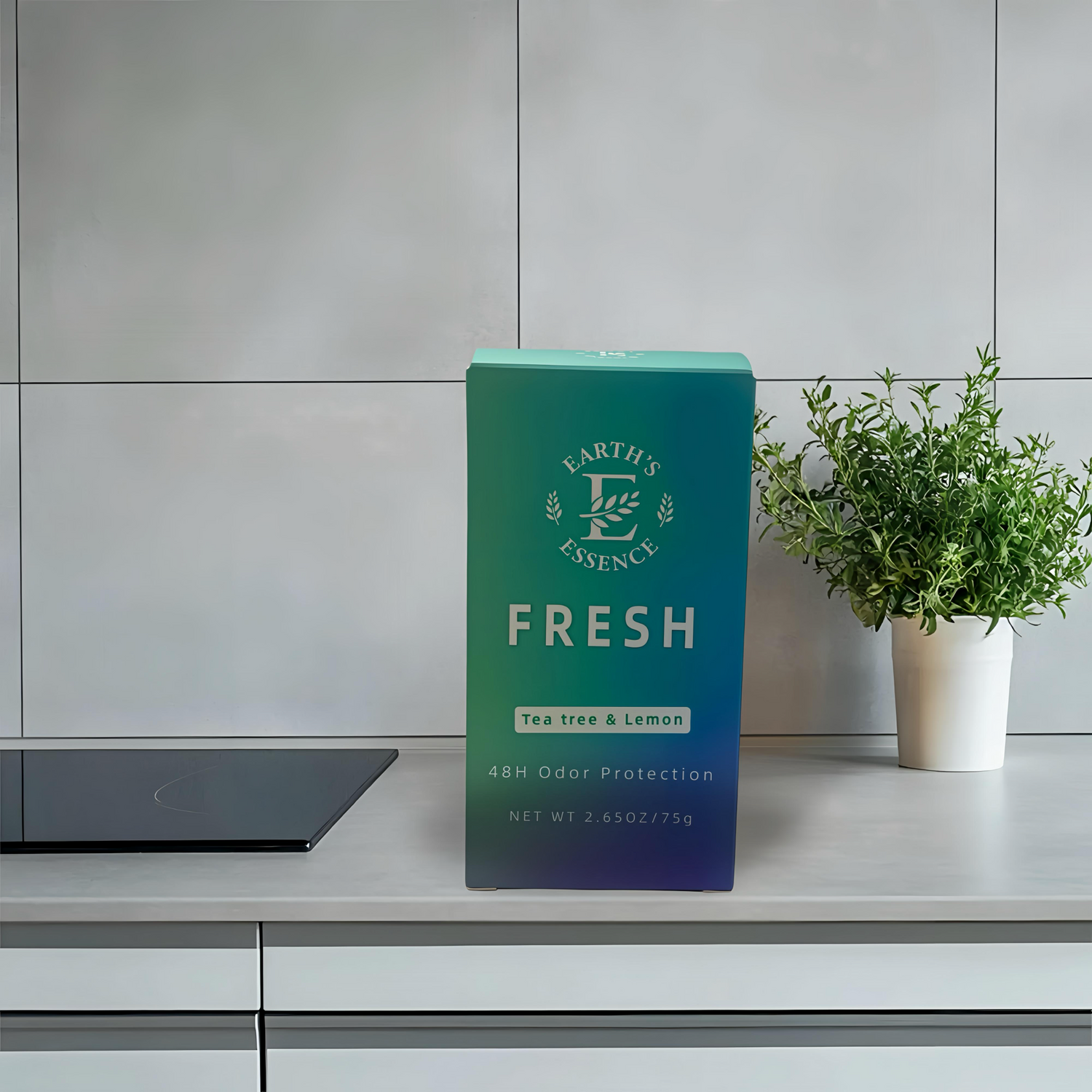 Green box labeled 'Earth's Essence Fresh' on a kitchen counter with a plant in the background