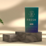 Green box labeled 'Earth's Essence Fresh' on a gray platform with a beige background